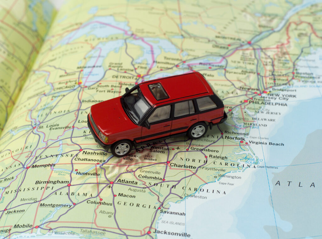red car driving across map of the united states how to check your driving record
