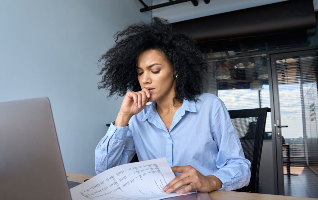 A business executive going through her financial documents before putting together an insolvency worksheet for the IRS.