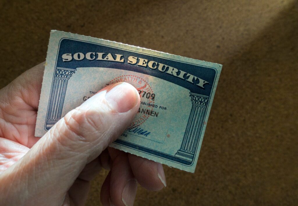 Close up of someone's hand holding their Social Security card.