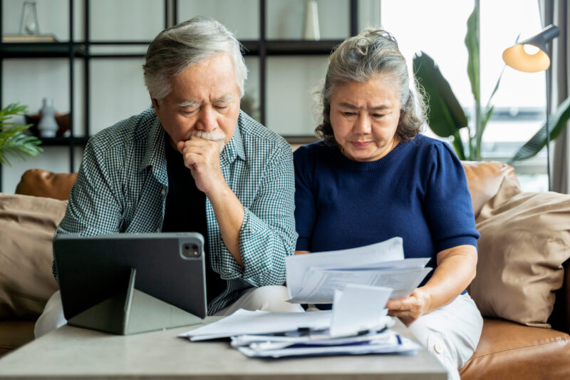 A married couple going through their records as they figure out how to pay their back taxes.