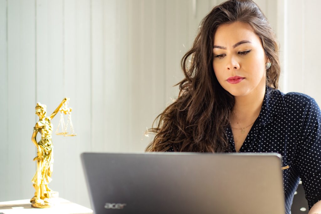 woman lawyer in professional clothes working at laptop to copyright images
