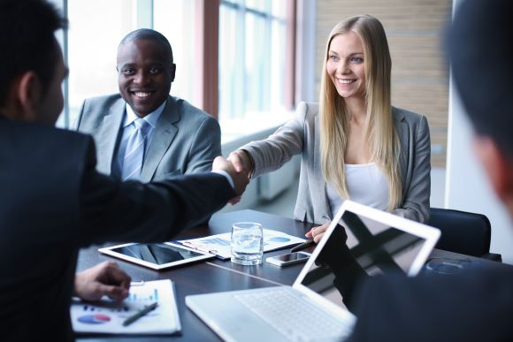 Professionals entering a general partnership and shaking hands in an office