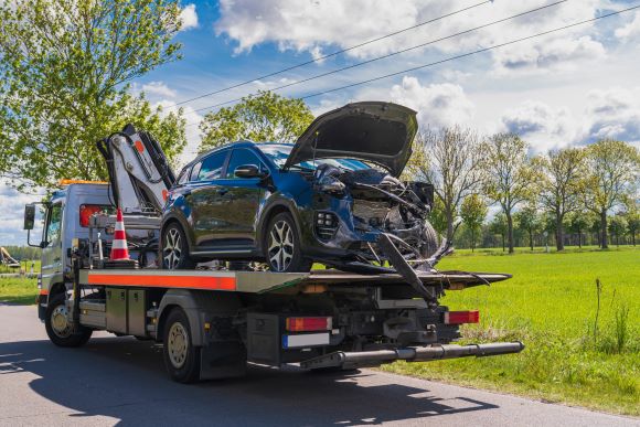 Salvage title car getting towed off the road