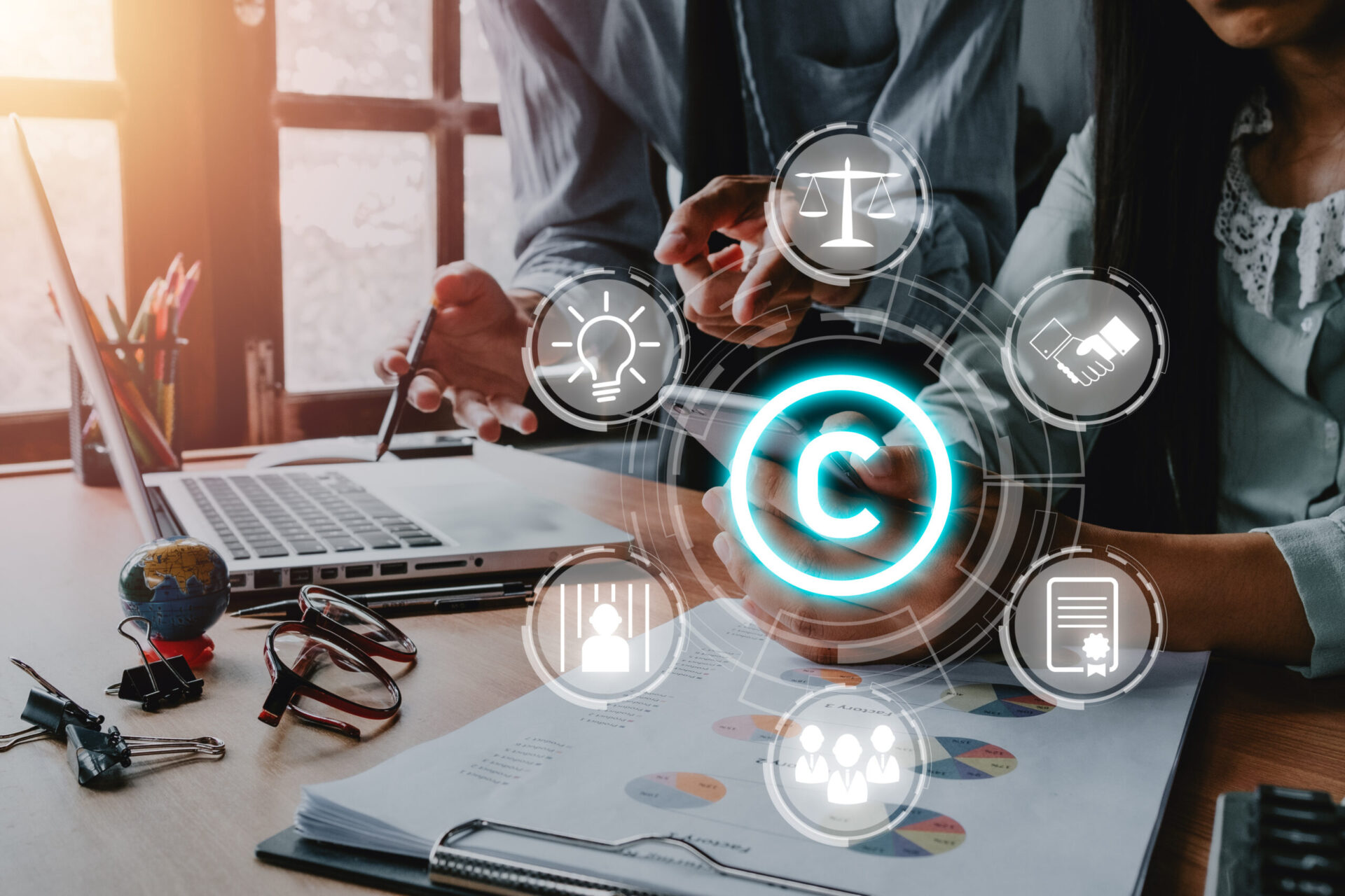 man and women in business office working at desk with graphic representation of how to get a copyright