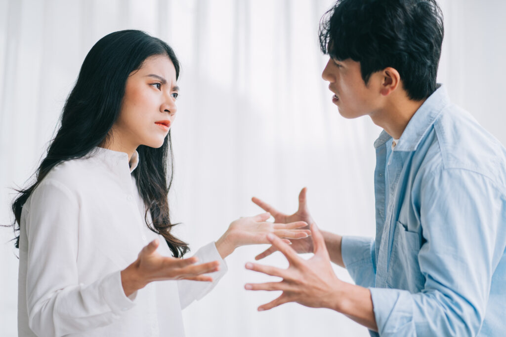 person with white shirt and long black hair arguing with person in blue shirt and short black hair about divorce without a lawyer