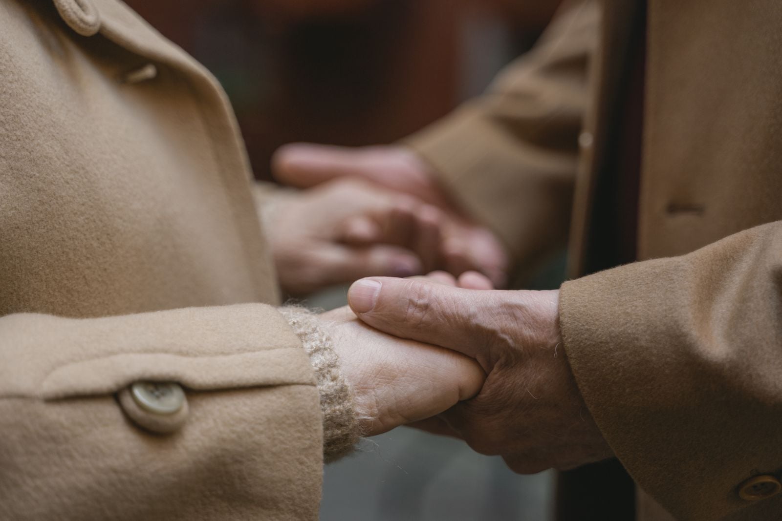 elderly couple holding hands